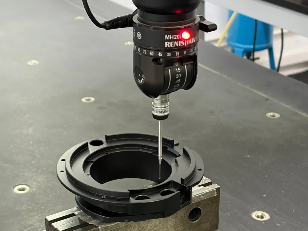 CMM probe positioned inside a ring-shaped component held in a fixture