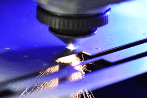 High-precision fiber laser cutting machine processing stainless steel sheet with sparks