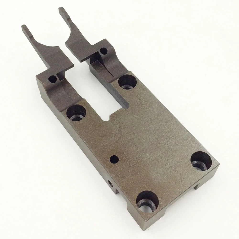 Fork-shaped steel component with a central opening and counterbored mounting holes