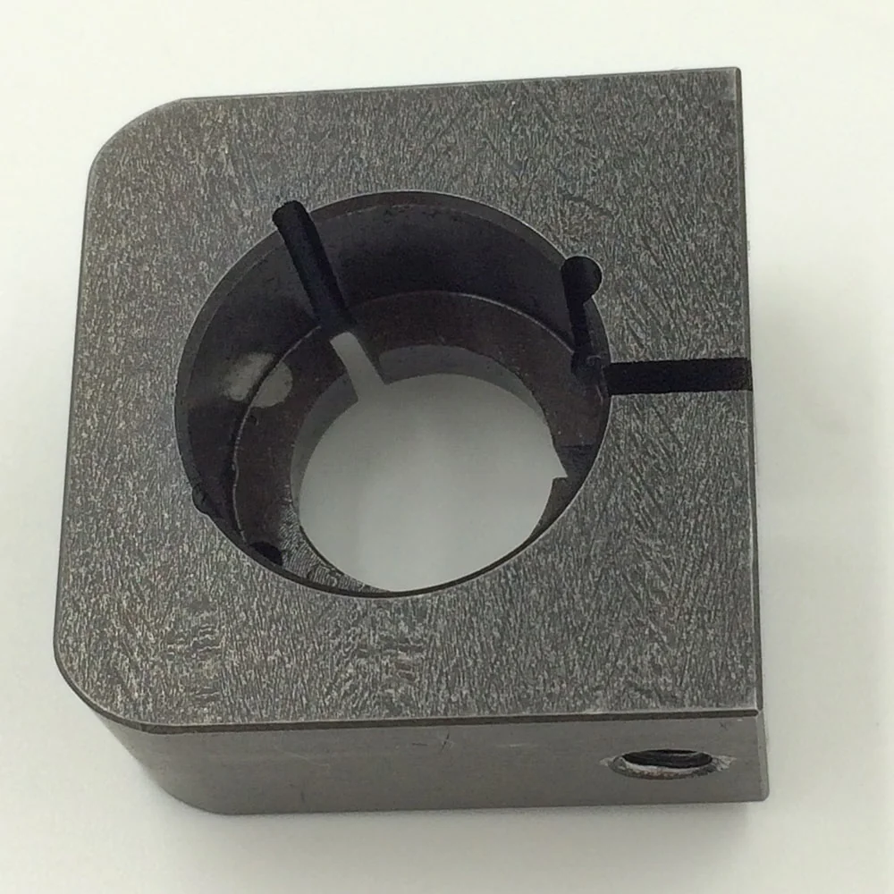 Steel component with a circular opening and narrow slots extending from the bore