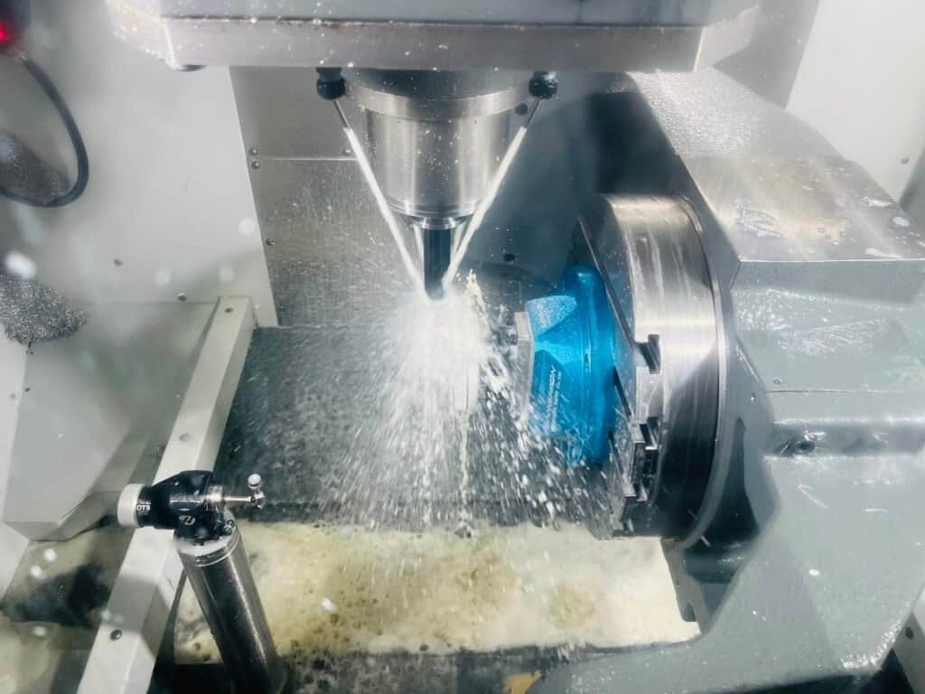 Simultaneous 5-axis CNC machining of a complex aerospace impeller with undercut features.