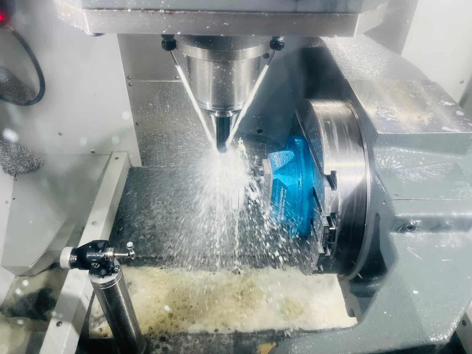 Simultaneous 5-axis CNC machining of a complex aerospace impeller with undercut features.