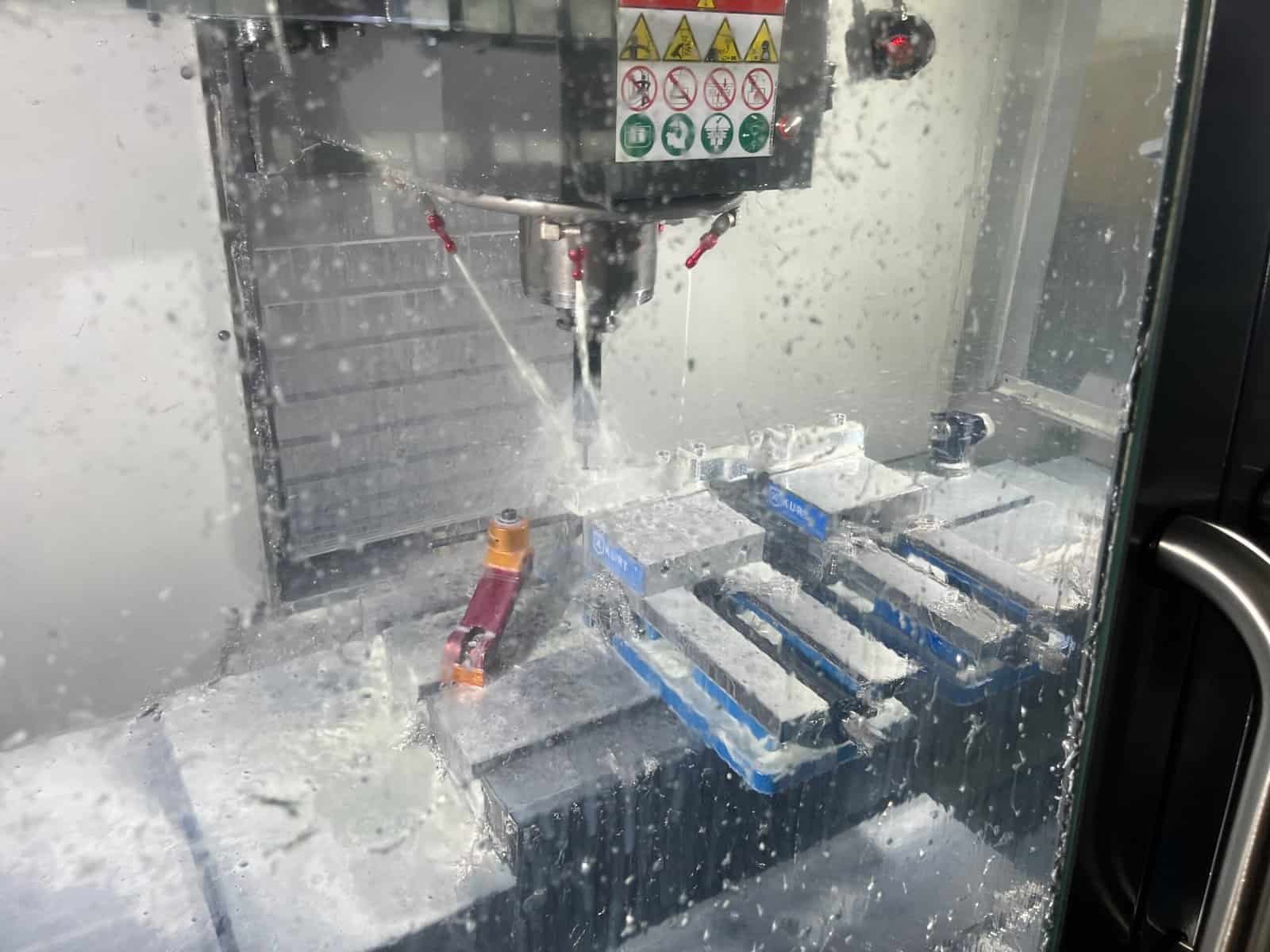 CNC milling 304 stainless steel using coolant to prevent work hardening and extend tool life.