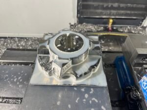 Complex CNC fixturing setup requiring manual adjustment and precise alignment for low-volume production.