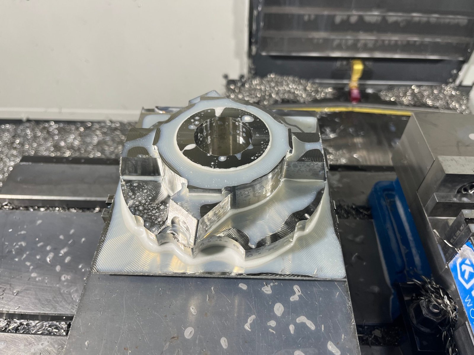 Complex CNC fixturing setup requiring manual adjustment and precise alignment for low-volume production.