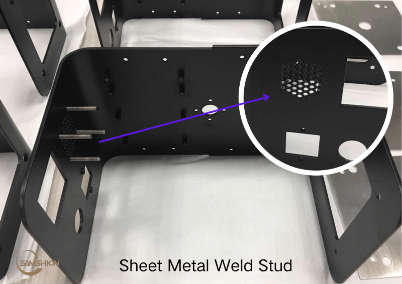 Black powder-coated sheet metal enclosure with welded studs and defect comparison coupons