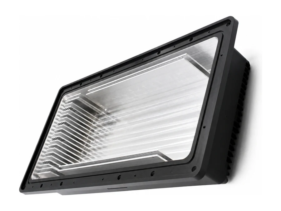 CNC-milled wireless communication housing with black anodized exterior and exposed aluminum cavity