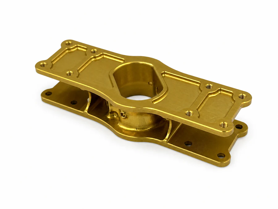 Gold-colored CNC-milled drone component with thin walls, lightening pockets and ribs