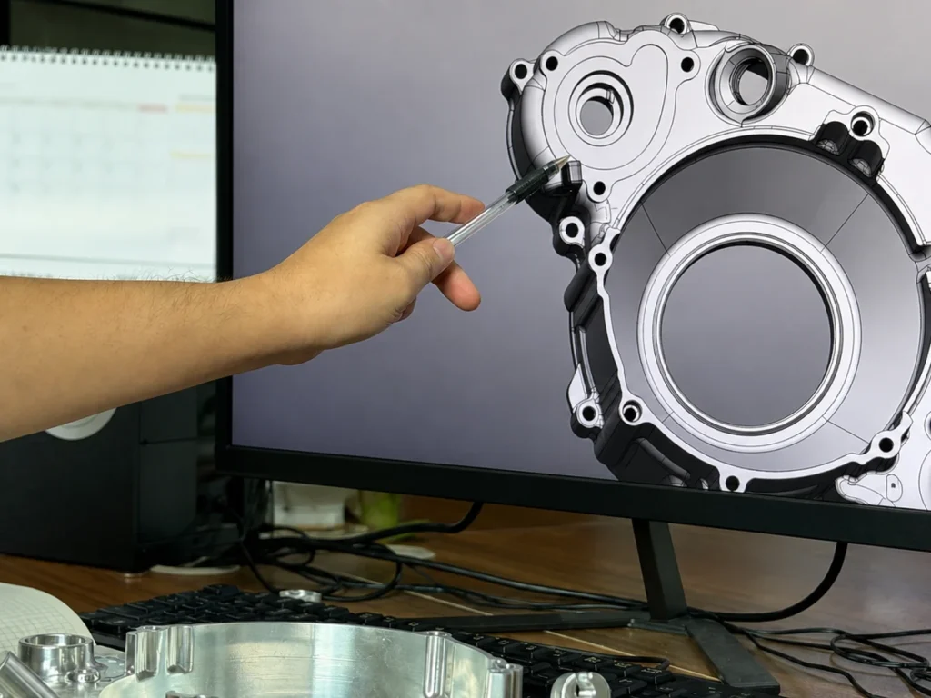 Engineer reviewing a CNC machined housing model before production