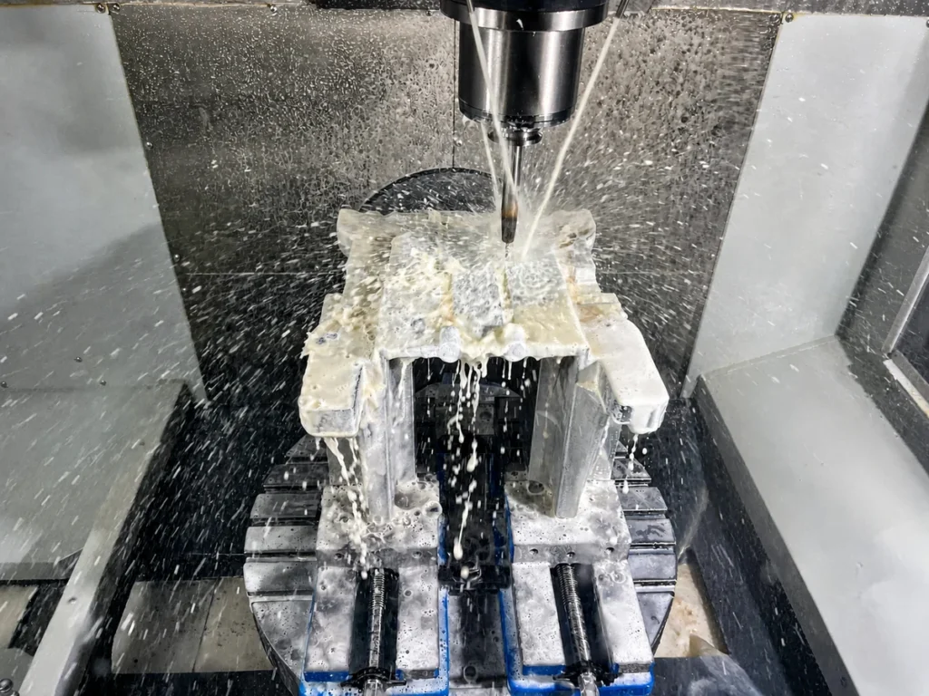 CNC milling an aluminum part with coolant inside a machining center