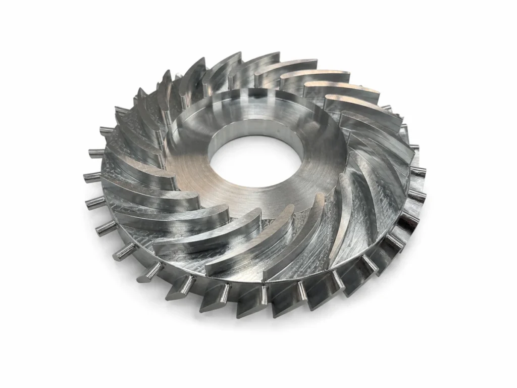 CNC machined prototype impeller on a white background