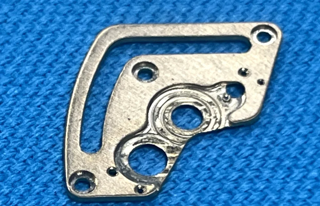 Incomplete spotface cleanup or burr at a machined seating feature
