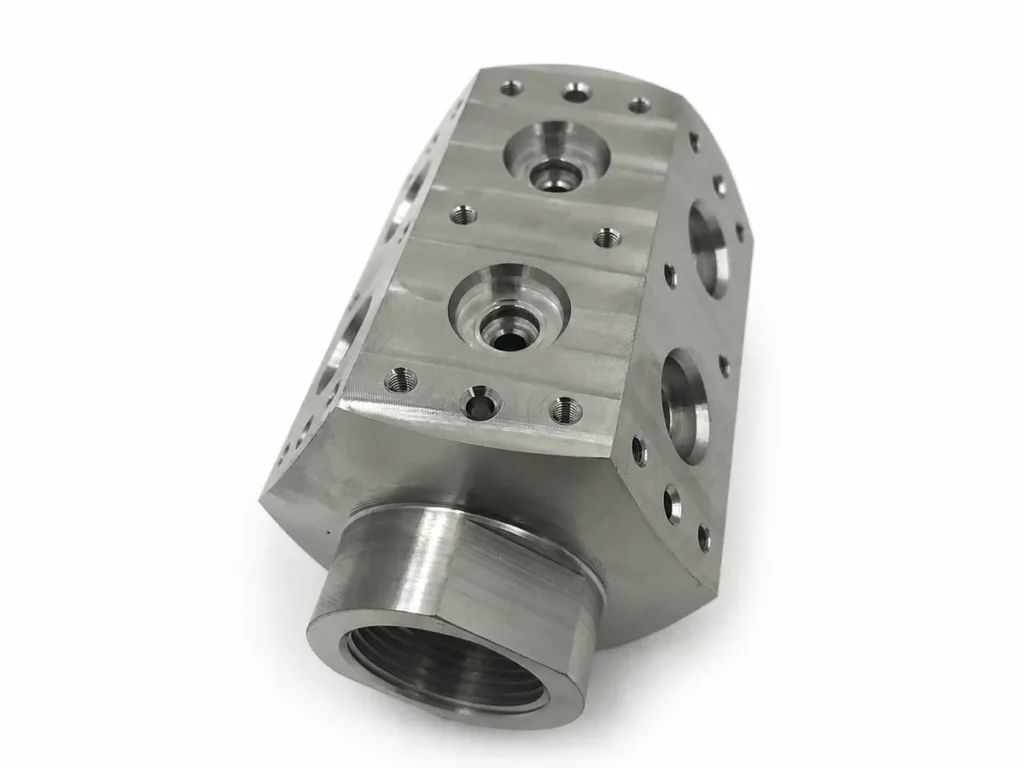 Machined titanium component with threaded holes, counterbored openings and multi-face features