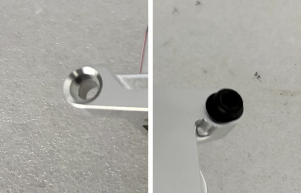 CNC machined part showing an empty countersink and a socket-head fastener at separate mounting points