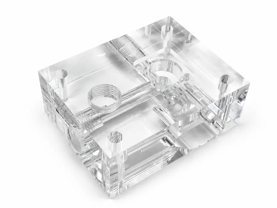 Real clear PMMA CNC machined component with threaded holes and internal channels