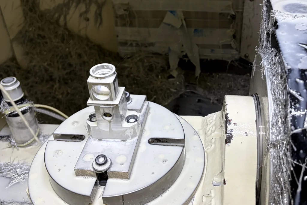 Real 5-axis CNC setup for machining an aluminum robotic joint component