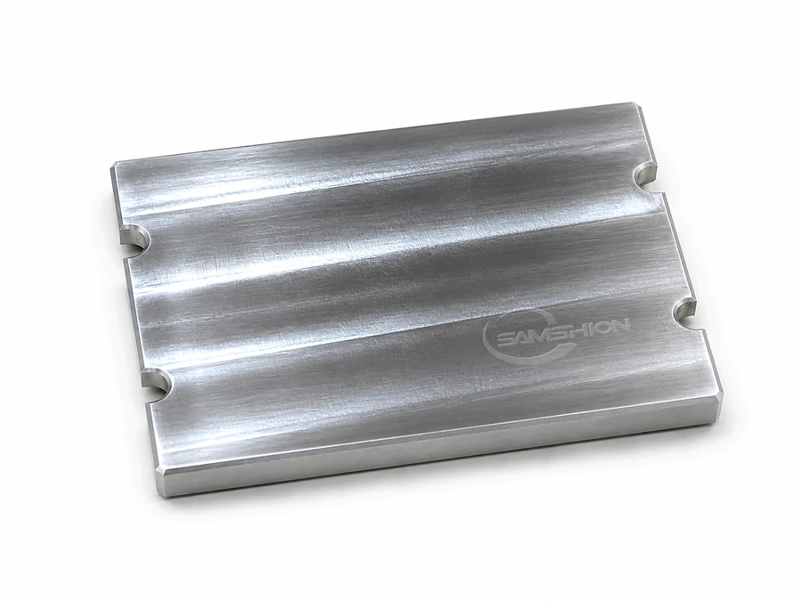 As-machined aluminum sample with visible CNC tool marks and laser-engraved SAMSHION logo