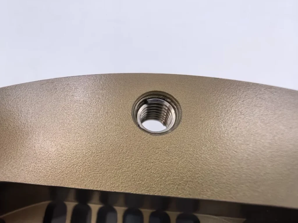 Thread insert installed in a CNC machined aluminum part
