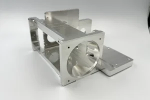 One-piece CNC machined aluminum bracket with large bores and mounting faces for infrared equipment