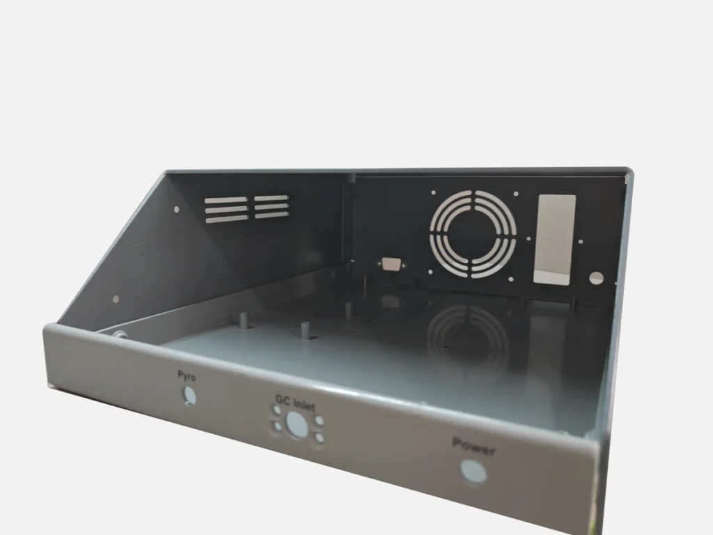 Gray powder-coated sheet metal equipment enclosure with ventilation openings and printed panel labels