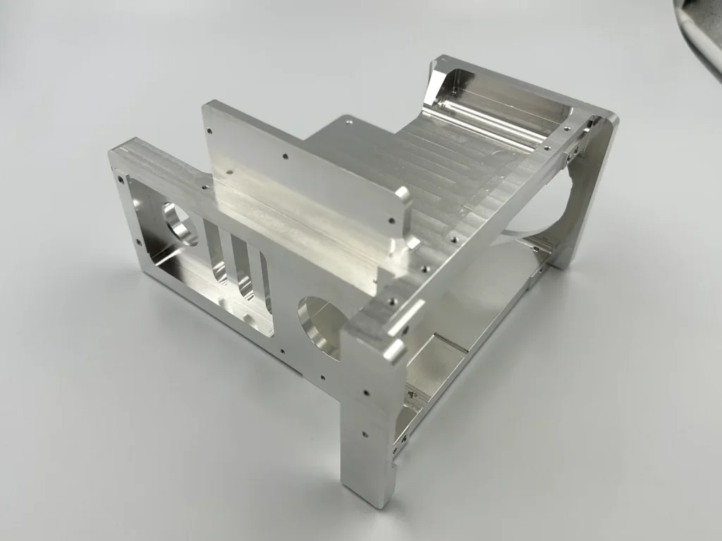 Alternate view of the aluminum bracket showing openings and mounting features on multiple faces