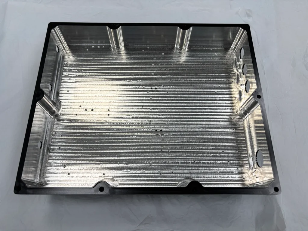 Aluminum enclosure interior with silver regions CNC machined after anodizing as specified by the customer