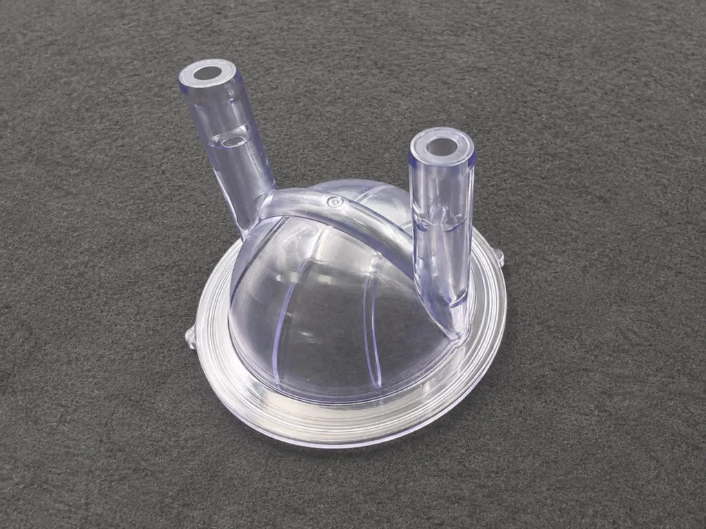 Transparent plastic prototype with two tubular features and a circular rim.