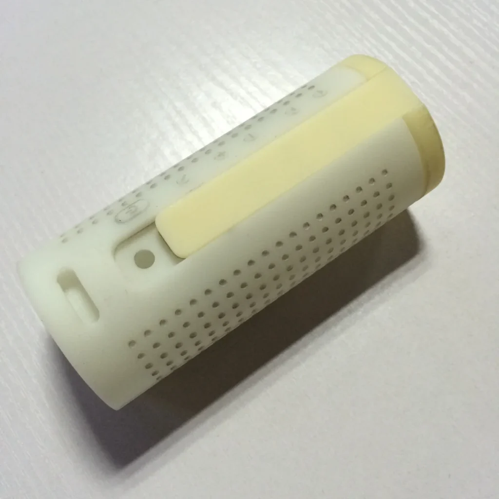 Assembled CNC-machined ABS prototype housing with perforated surfaces and fitted exterior components