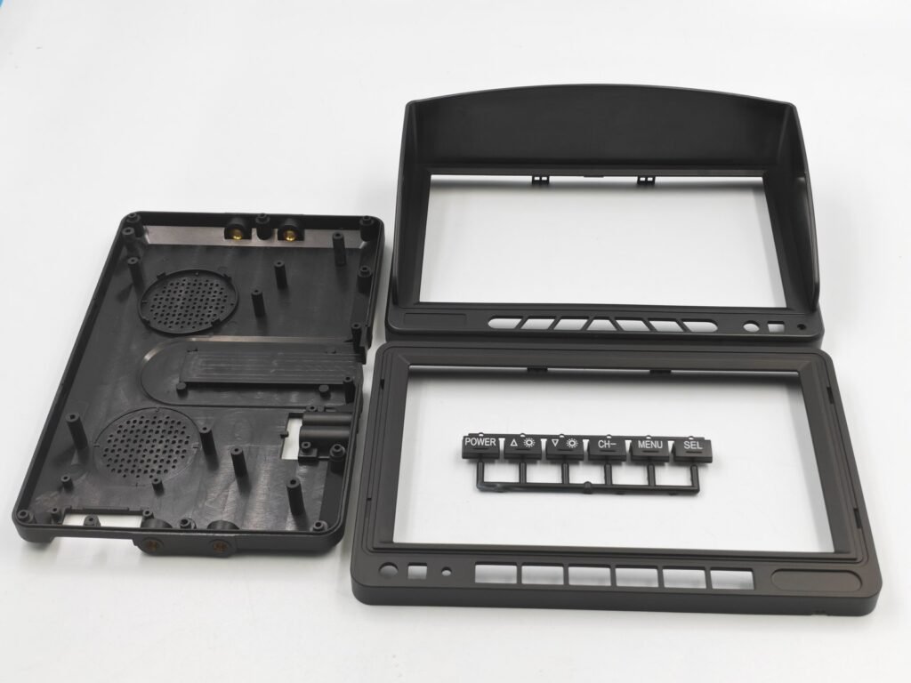 Black ABS vehicle recorder housing components with front frames, button openings and a separate button strip