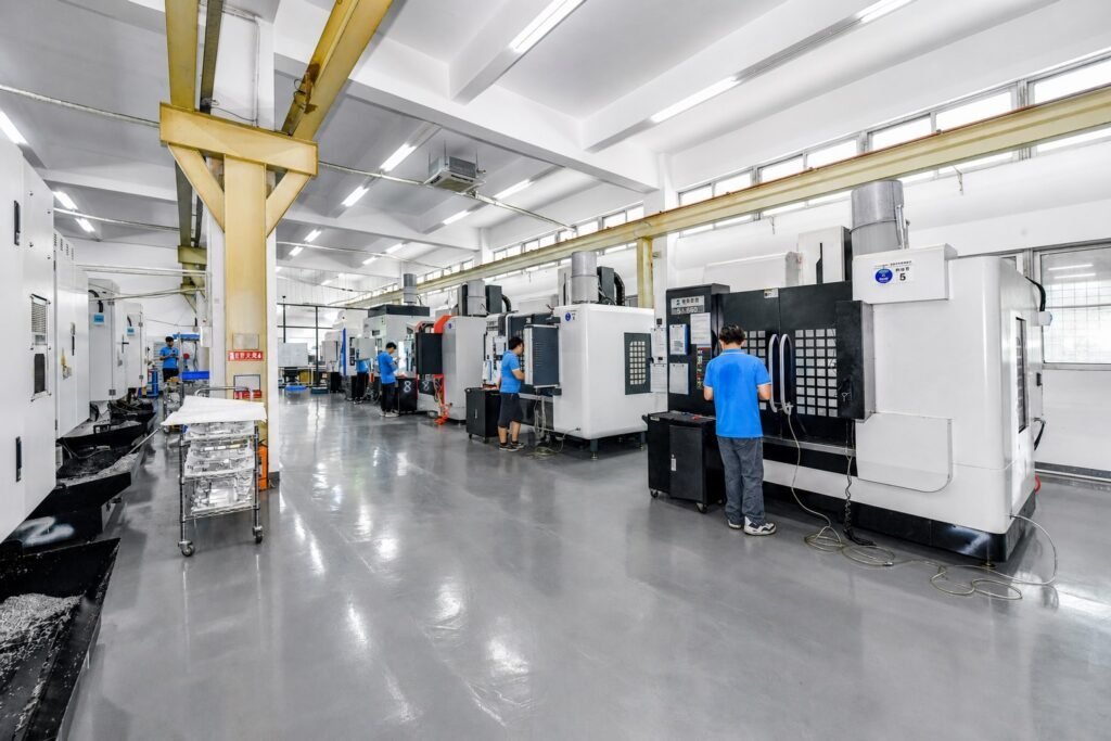Operators working beside CNC machining centers in the SAMSHION workshop