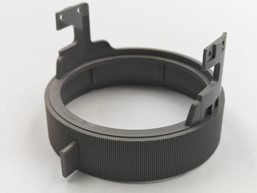 Dark PA+GF ring-shaped component for optical equipment with mounting brackets, holes and a finely ridged outer surface