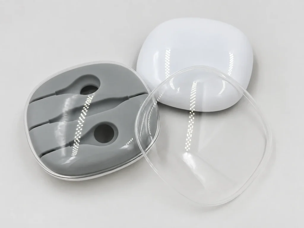 Headphone case prototype with a clear PMMA cover, a white ABS housing and a gray soft component.