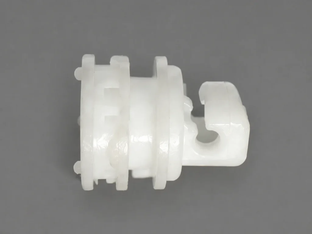 White POM injection-molded component with circular flanges and an open-sided feature, produced by SAMSHION using rapid tooling.