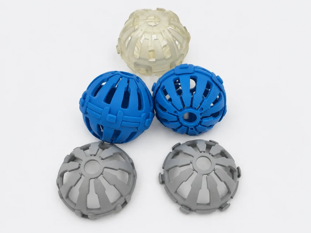 Five vacuum cast prototype pieces in blue, gray and translucent finishes with open ribbed geometry.