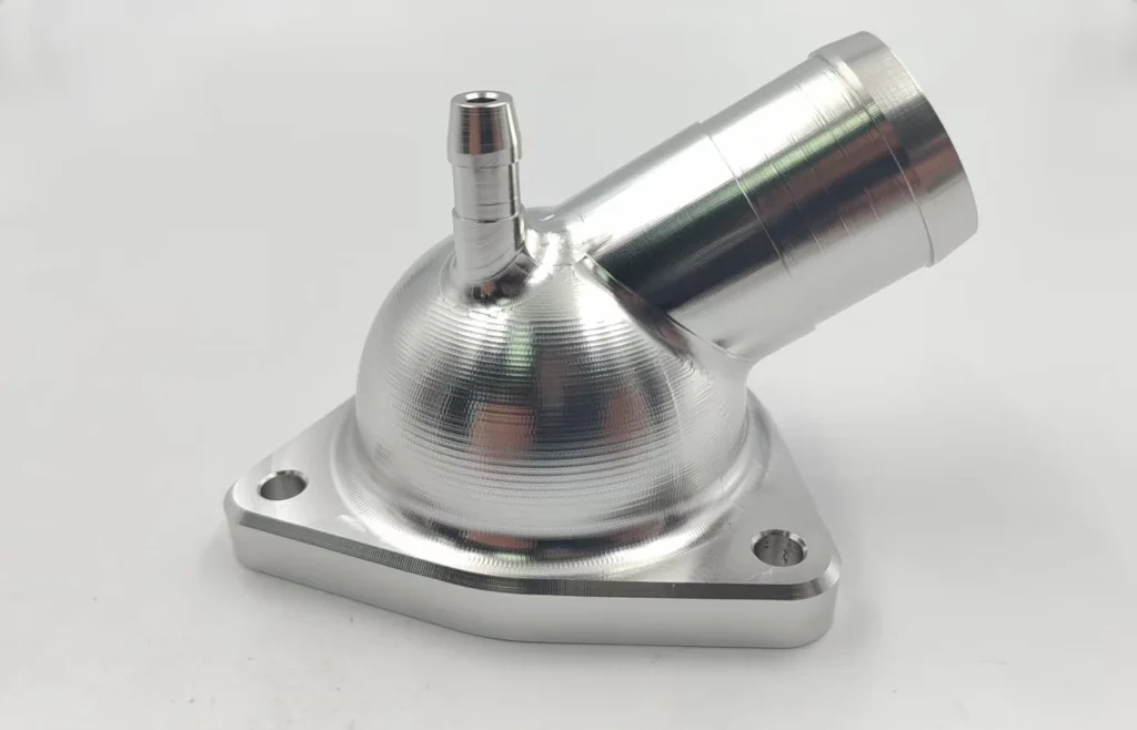As-machined 6061-T6 automotive component with a spherical surface and angled ports produced using simultaneous 5-axis machining