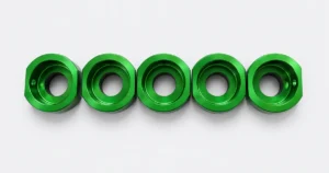 Five green CNC machined sleeves with stepped internal bores