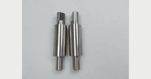 Two machined stepped shafts with different outside diameters and end flats