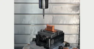 Copper CNC machining setup with a copper workpiece held in a machine vise