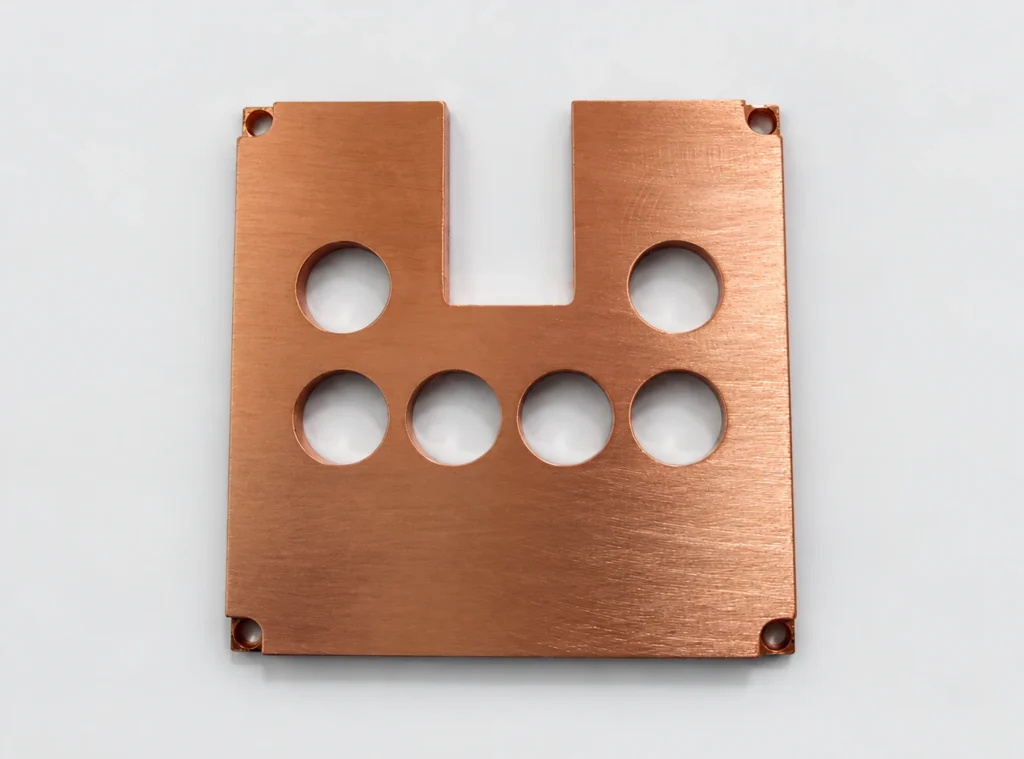 As-machined copper plate with six large through holes and an open central notch
